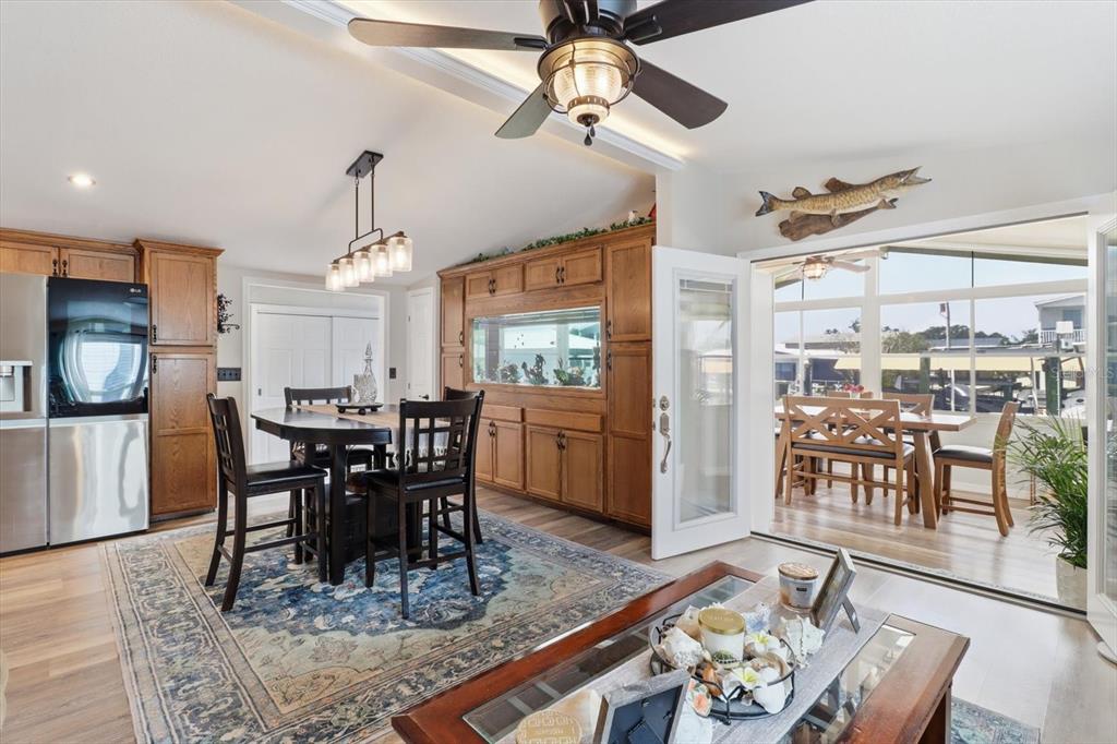 A dining area features wooden cabinetry, a built-in aquarium, and a view of a sunroom — 11639 W CLEARWATER COURT, HOMOSASSA, FL