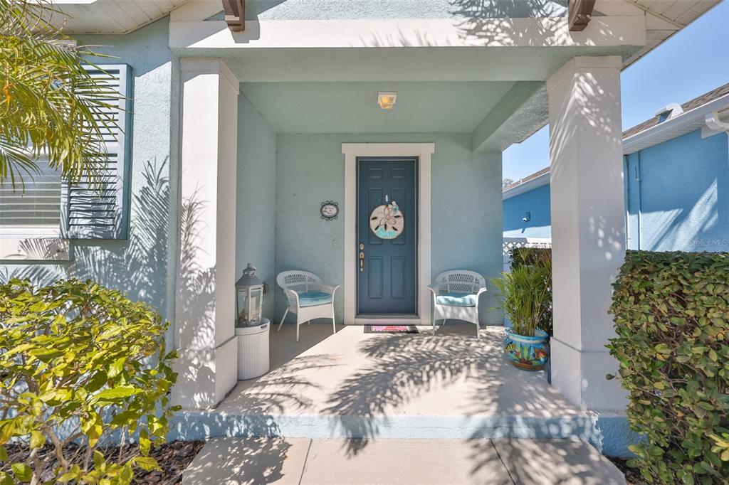 A cream-colored tower with a gated entrance stands beside a blue MiraBay community sign — 5227 ADMIRAL POINTE DRIVE, APOLLO BEACH, FL