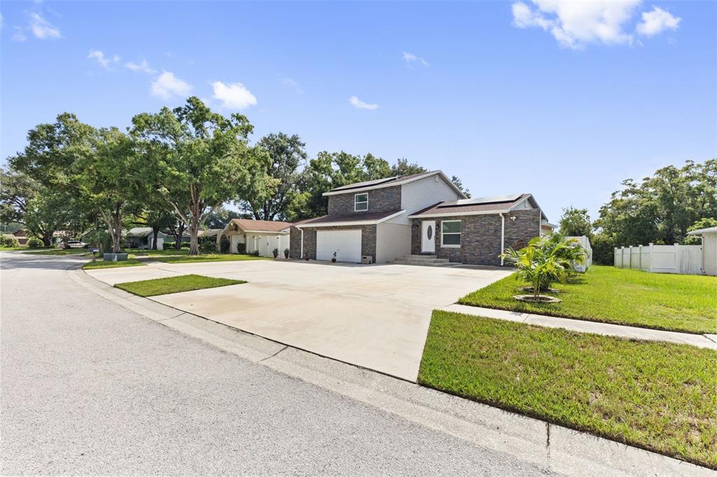 A two-story house with a stone facade and a large concrete driveway — 5408 PENTAIL CIRCLE, TAMPA, FL