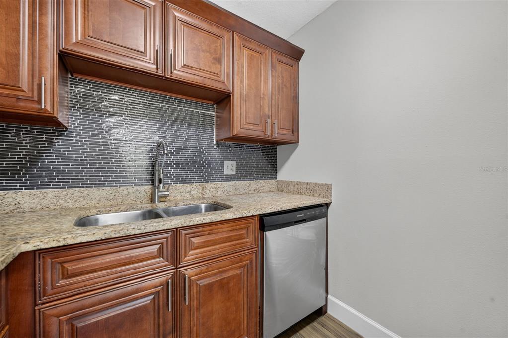 A dining room features a round marble table, four upholstered chairs, and a sliding glass door — 118 W AMERICA STREET UNIT 2, ORLANDO, FL