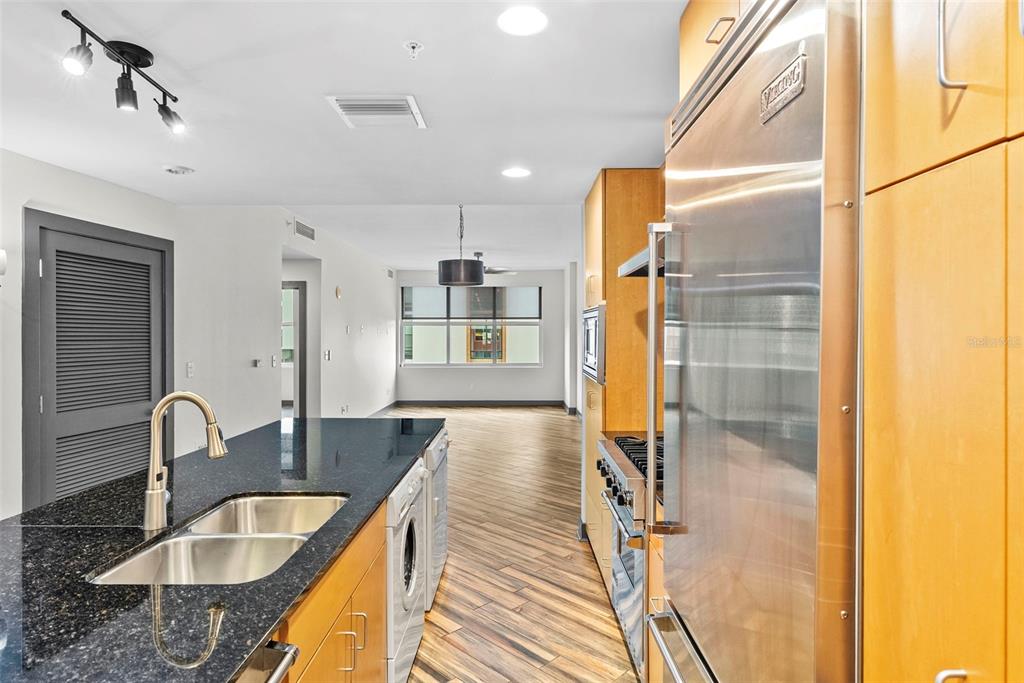A kitchen with dark granite countertops, light wood cabinets, and stainless steel appliances — 1120 E KENNEDY BOULEVARD UNIT 618, TAMPA, FL