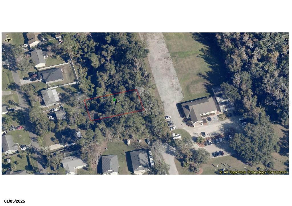 This aerial map shows a wooded residential lot outlined in red — 252 ACACIA ROAD, DEBARY, FL