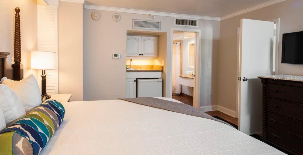 A hotel room featuring a bed, a small kitchenette area, and an attached bathroom — 5500 GULF BOULEVARD UNIT 2249, ST PETE BEACH, FL