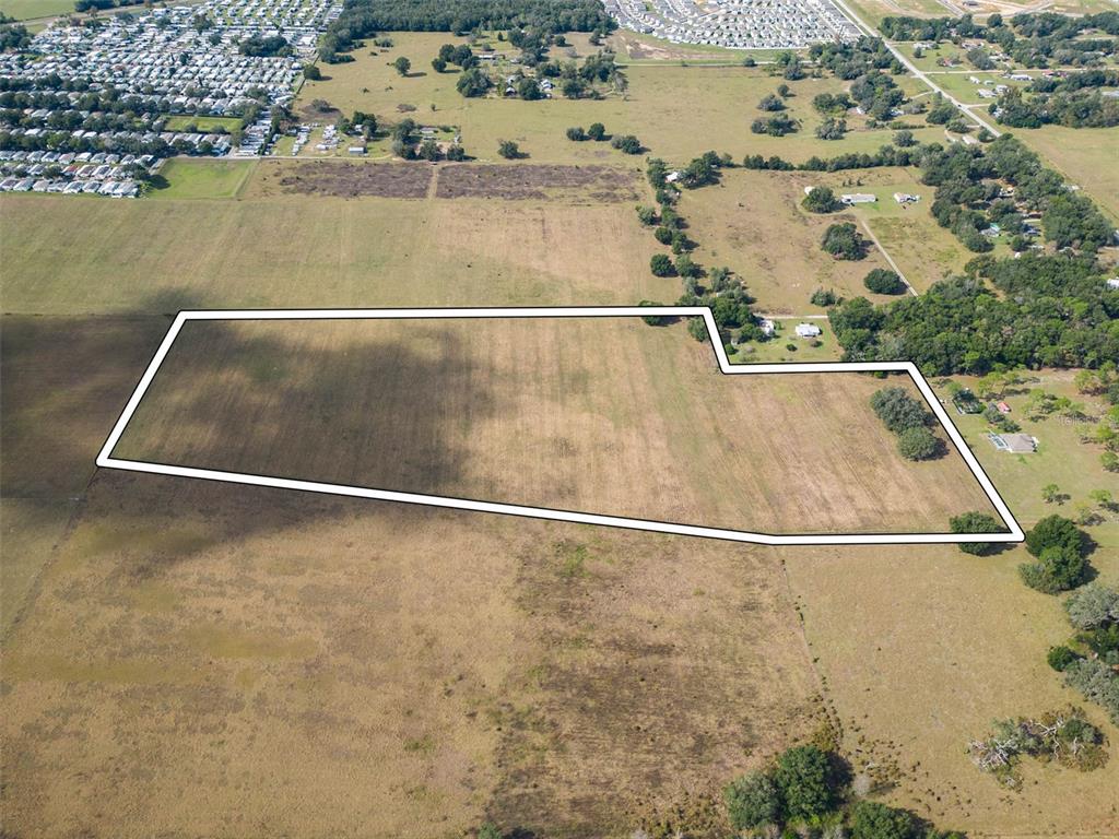 An aerial view shows a large, irregularly shaped plot of land outlined in white — BUR MAC ROAD, DADE CITY, FL