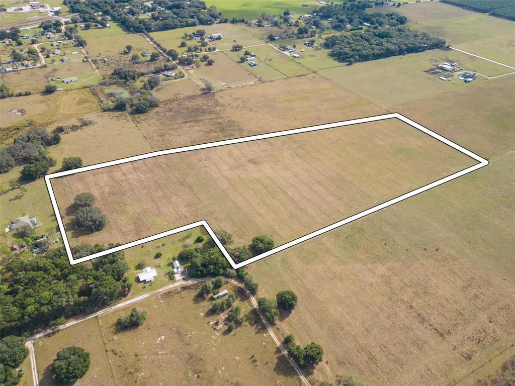 An aerial view shows a large, rectangular plot of land outlined in white — BUR MAC ROAD, DADE CITY, FL