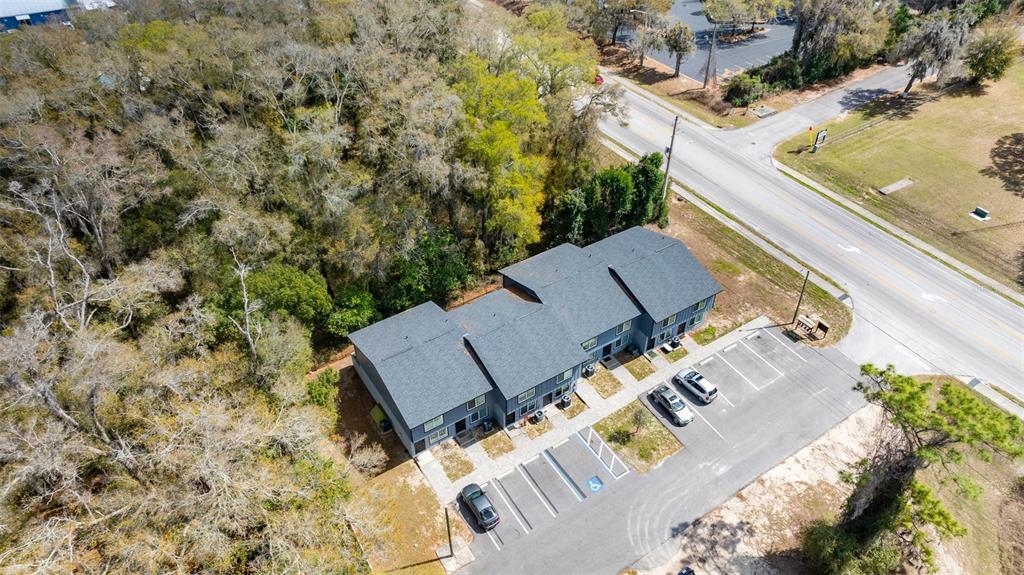 An aerial view shows a multi-unit residential building with a parking lot and surrounding trees — 3041 SW 20TH STREET, OCALA, FL