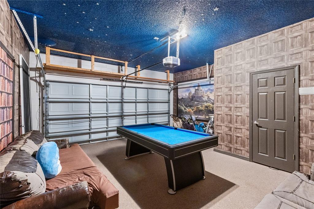A living room features a leather sofa, a tiled coffee table, and animal-themed decor — 180 HIDEAWAY BEACH LANE, KISSIMMEE, FL