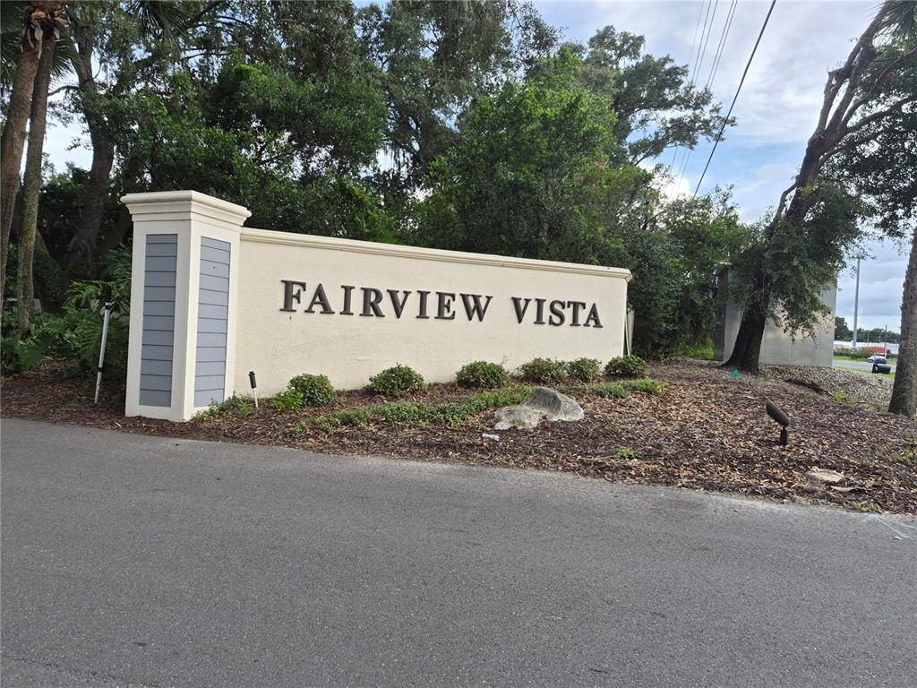 A kitchen features cream-colored cabinets, dark granite countertops, a tiled backsplash, and stainless steel appliances — 4101 FAIRVIEW VISTA POINT UNIT 230, ORLANDO, FL