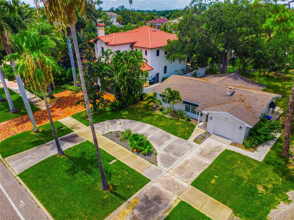 An aerial view shows a single-story house with a garage next to a larger villa — 910 SNELL ISLE BOULEVARD NE, ST PETERSBURG, FL