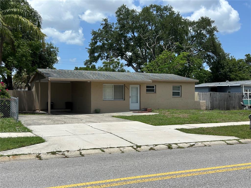 A single-story house with a carport, concrete driveway, and a front yard — 6971 78TH AVENUE N, PINELLAS PARK, FL