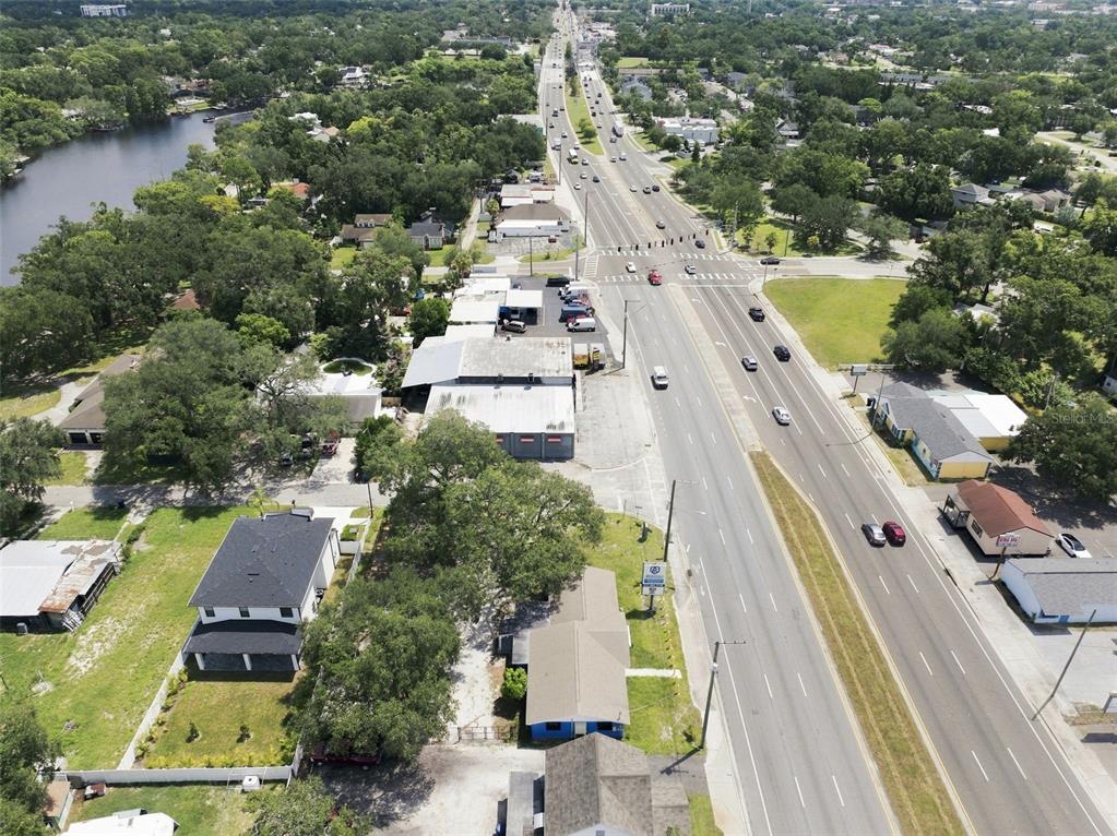 An aerial view shows a commercial property along a multi-lane road near a lake — 901 W HILLSBOROUGH AVENUE, TAMPA, FL