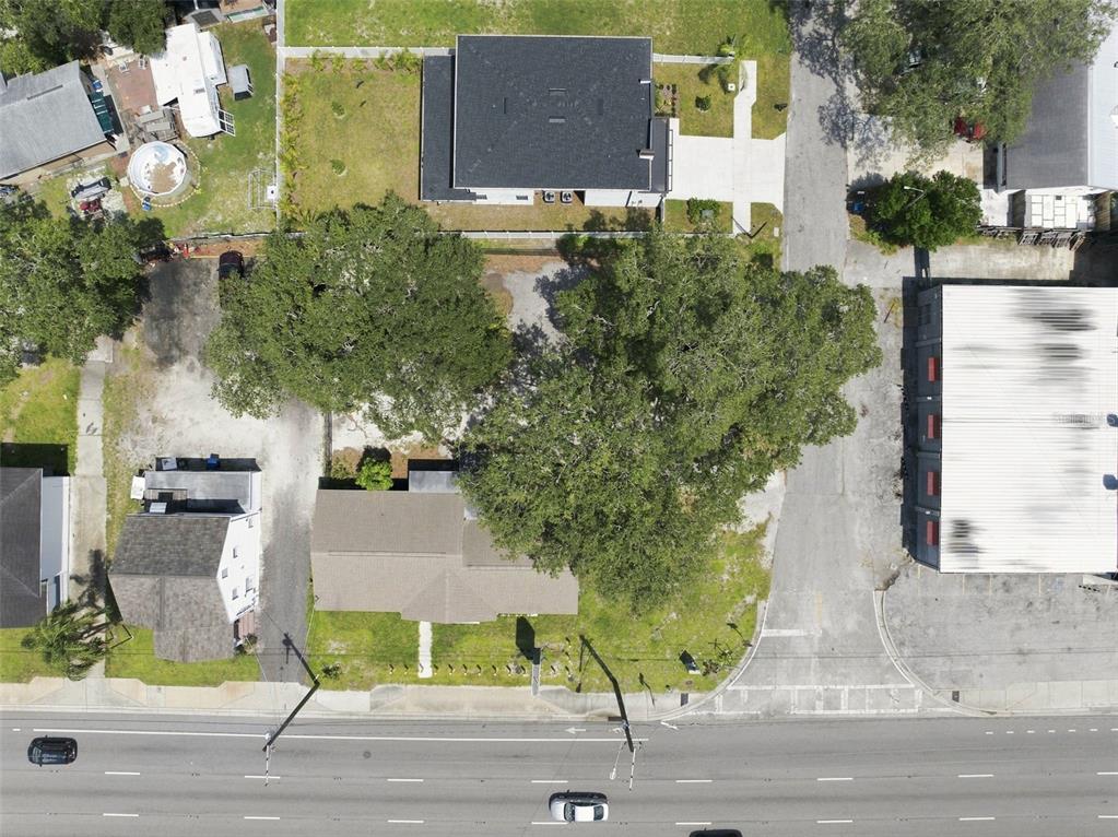An aerial view shows a residential property with a house, large trees, and adjacent buildings — 901 W HILLSBOROUGH AVENUE, TAMPA, FL