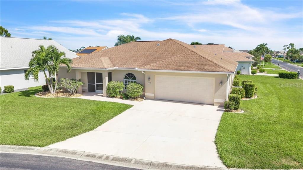 A single-story house with a tan exterior, a two-car garage, and a brown shingled roof — 3455 SABAL SPRINGS BOULEVARD, NORTH FORT MYERS, FL
