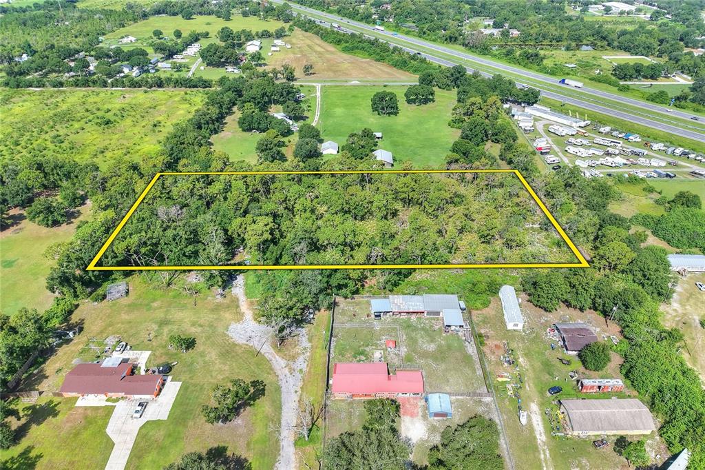 An aerial view shows a wooded rectangular lot with a 30-foot easement access path — SE 33RD STREET, RUSKIN, FL