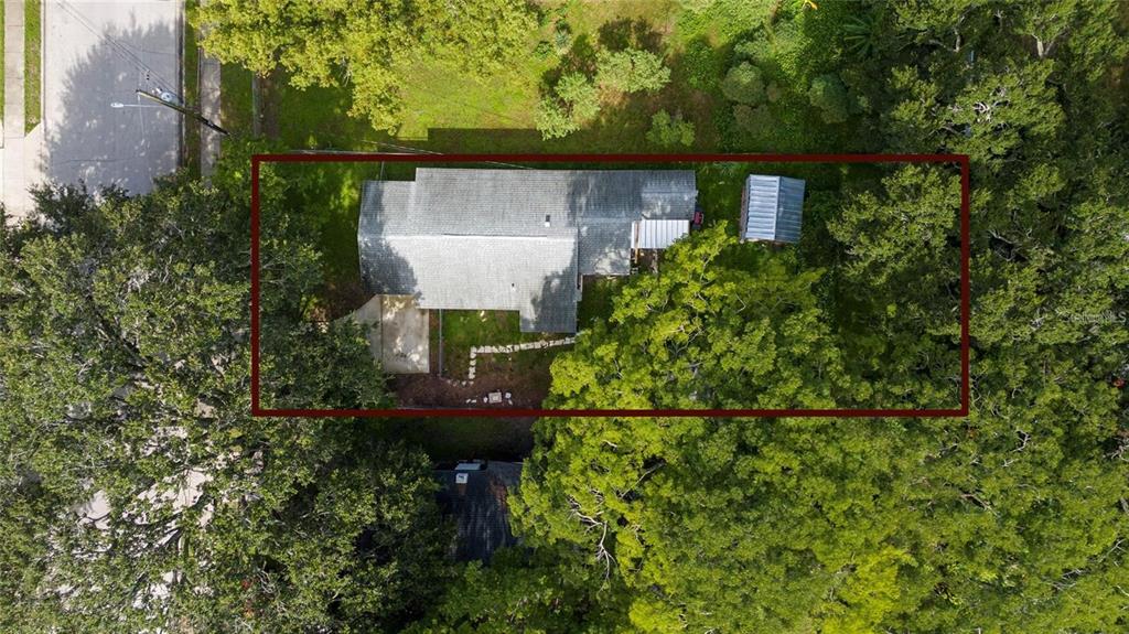 An aerial view shows a house with a gray roof, a driveway, and a small shed — 713 22ND STREET, ORLANDO, FL
