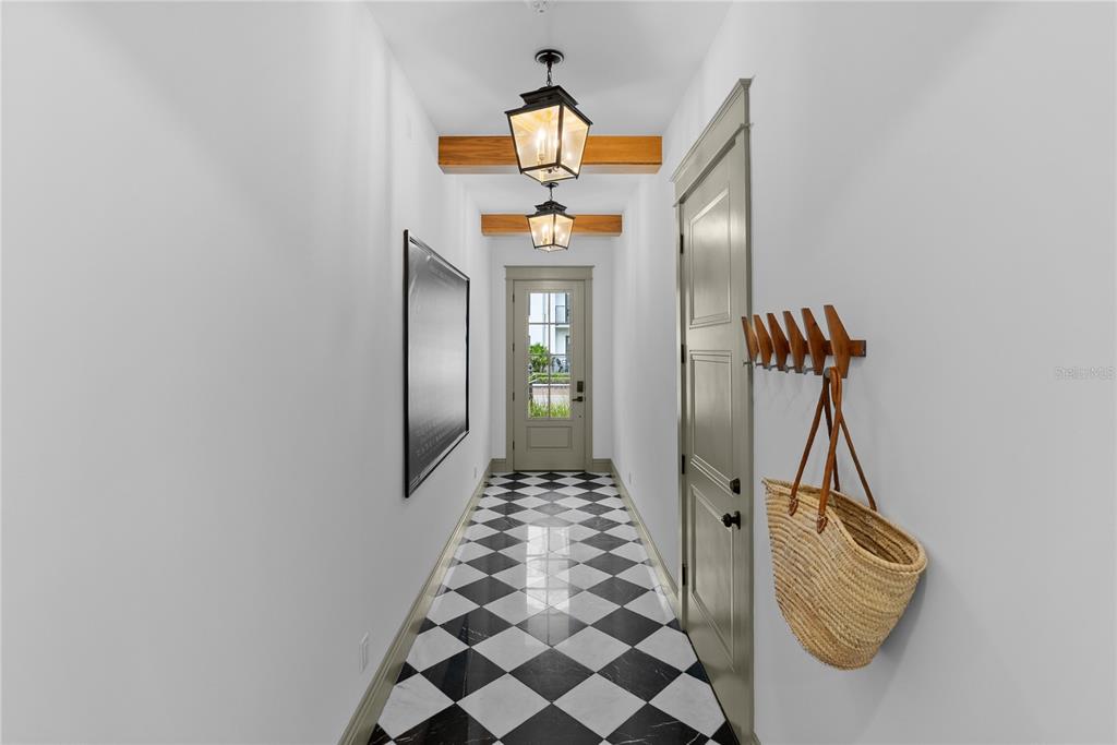A narrow hallway features a black and white checkered floor, two pendant lights, and wood beams — 417 W ROSS AVENUE UNIT 2, TAMPA, FL