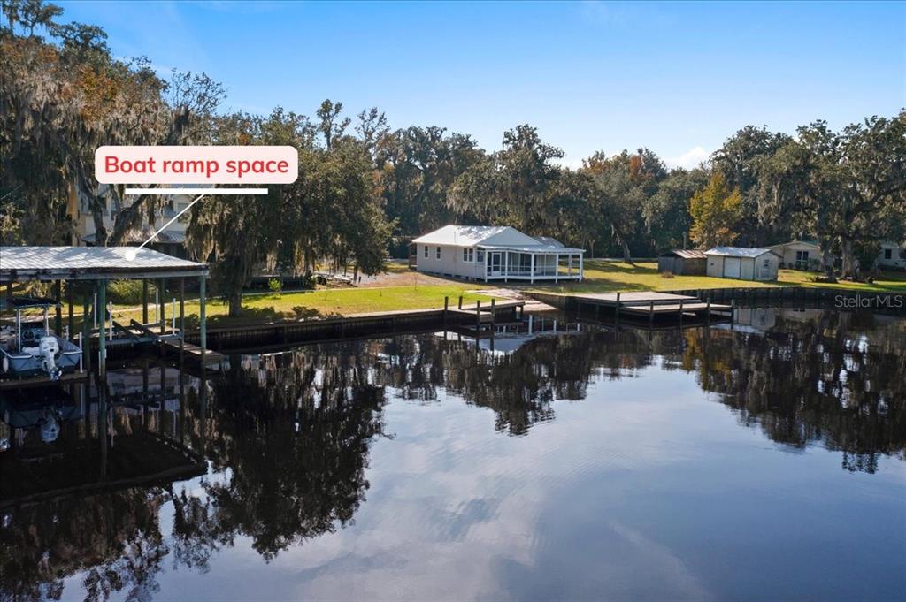 A waterfront property features a boat dock, a boat ramp, and a small house — 13555 COUNTY ROAD 13, ST AUGUSTINE, FL