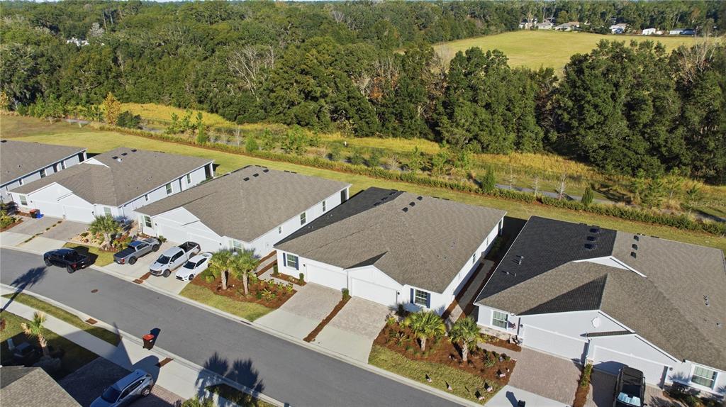 An aerial view shows a row of suburban houses with driveways and attached garages — 5341 NW 48TH PLACE, OCALA, FL