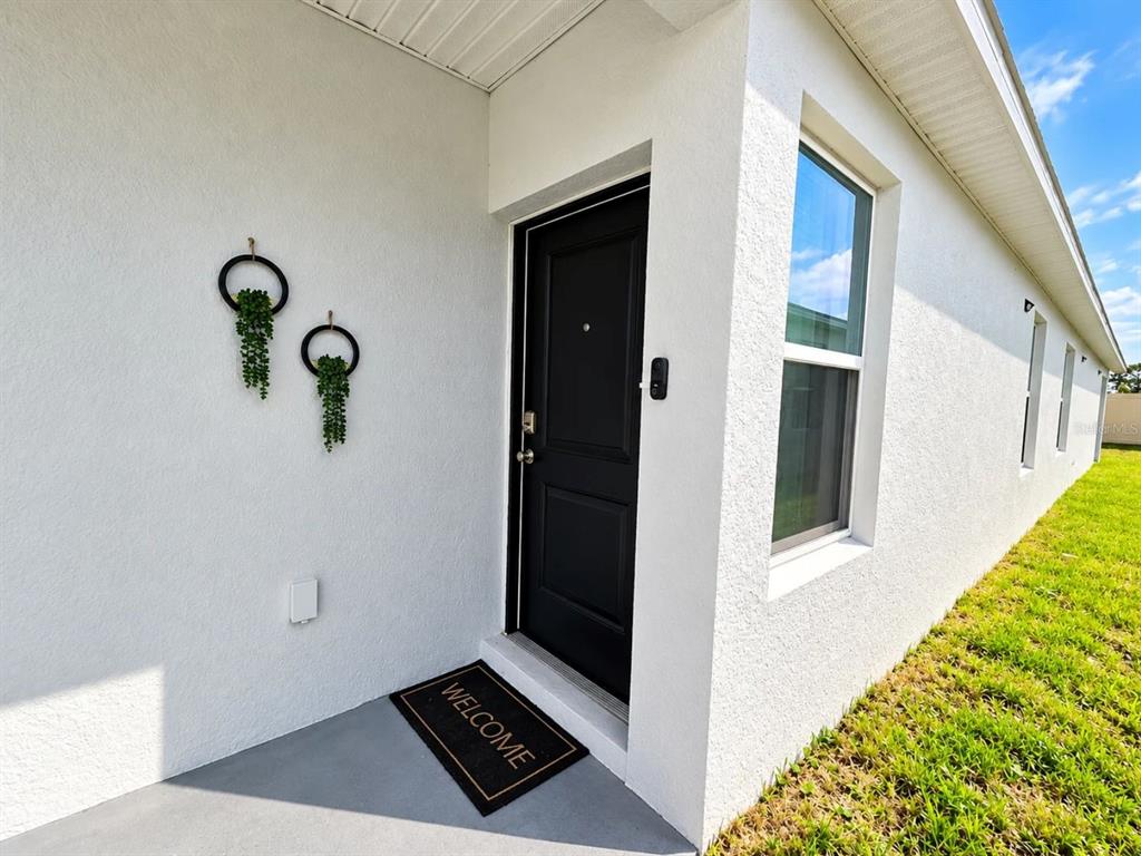 A view from an interior doorway looking out to a porch and a laundry room — 5539 MADDIE DRIVE, HAINES CITY, FL
