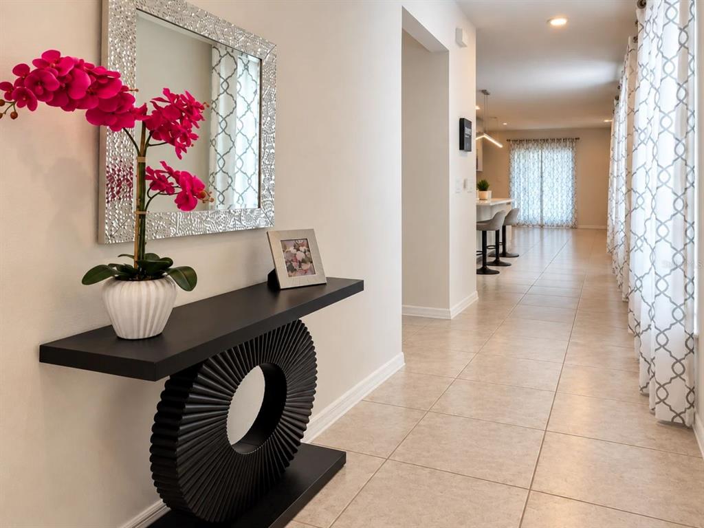 A laundry room features a white washer and dryer, a window, and a wire shelf — 5539 MADDIE DRIVE, HAINES CITY, FL