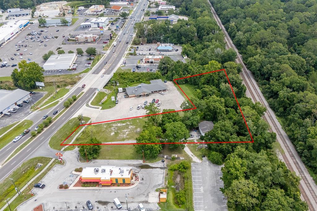 An aerial view shows a commercial property lot outlined in red next to a road — S WALNUT STREET, STARKE, FL