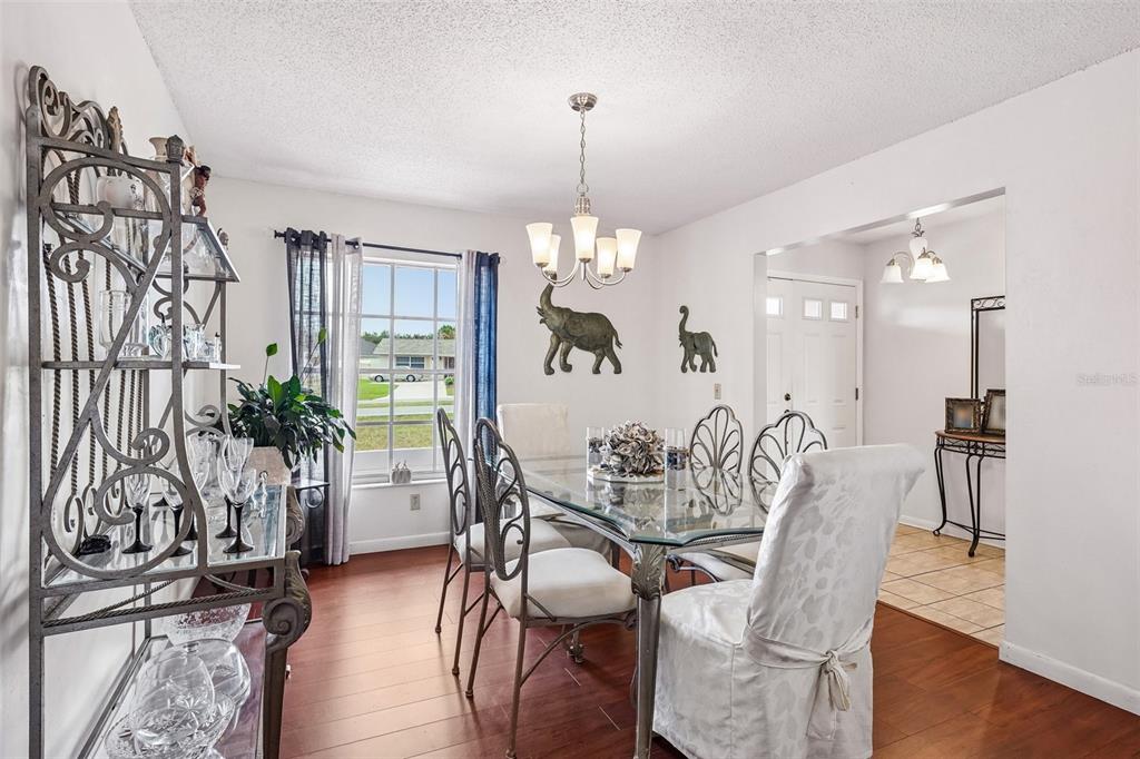 A kitchen features wood cabinets, stainless steel appliances, and a gray marble-patterned backsplash — 3777 PARKWAY BOULEVARD, LAND O LAKES, FL