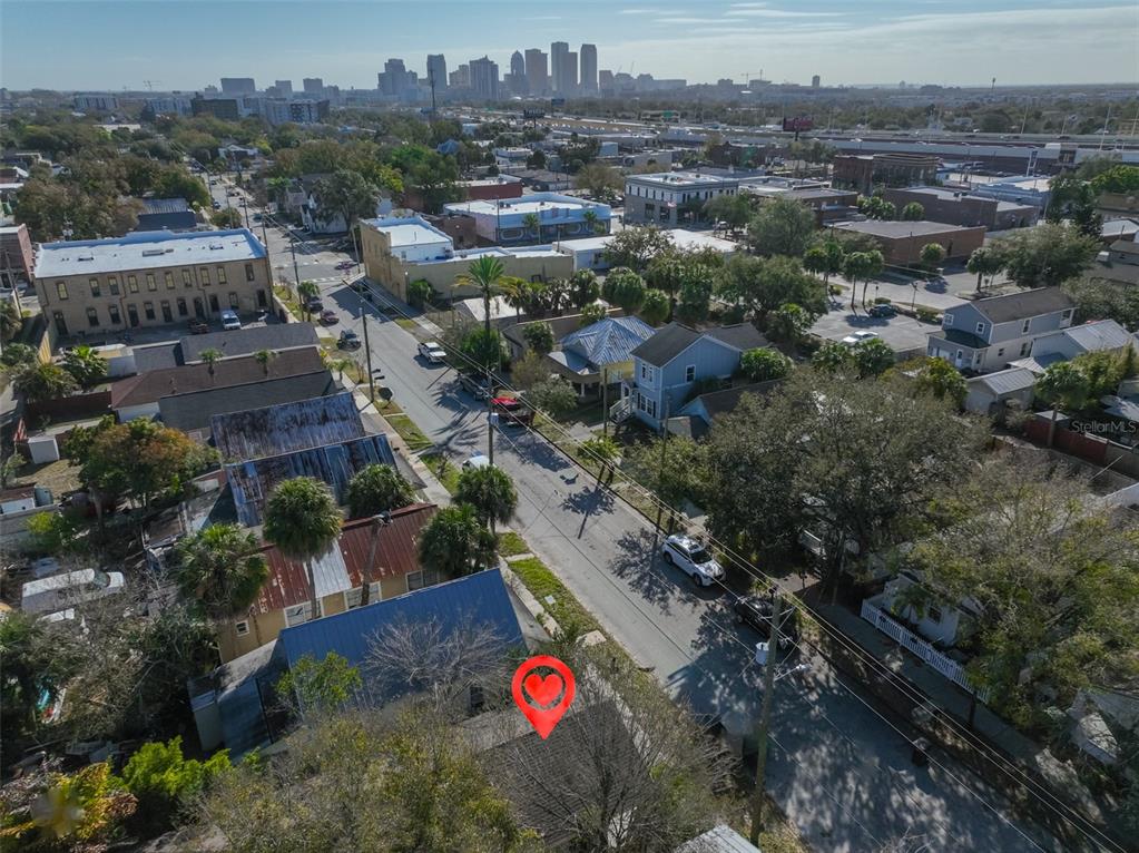 An aerial view shows a residential street with houses and a distant city skyline — 2331 W CHESTNUT STREET, TAMPA, FL
