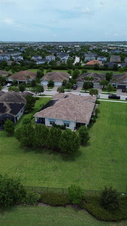 An aerial view shows a residential house with a tiled roof and a large backyard — 19610 WEATHERVANE WAY, LOXAHATCHEE, FL