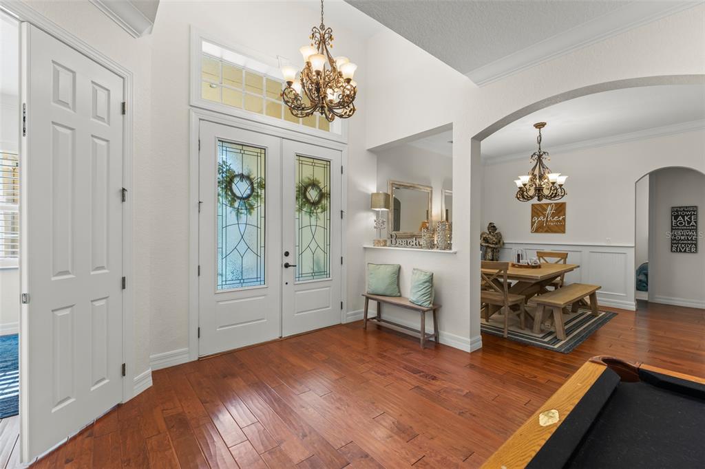 An entryway with hardwood floors, a double front door, and an adjacent dining area — 2108 TILLMAN AVENUE, WINTER GARDEN, FL