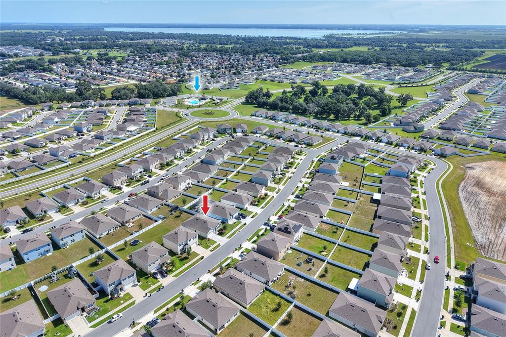 An aerial view shows a residential neighborhood with a community pool and many single-family homes — 3645 DIVING DOVE LANE, BARTOW, FL