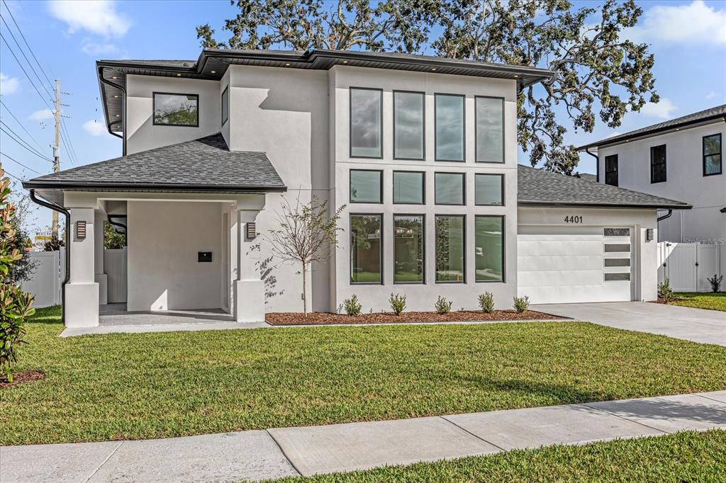 A modern two-story house with a white exterior, large windows, and an attached garage — 4401 ROCKLEDGE ROAD, ORLANDO, FL
