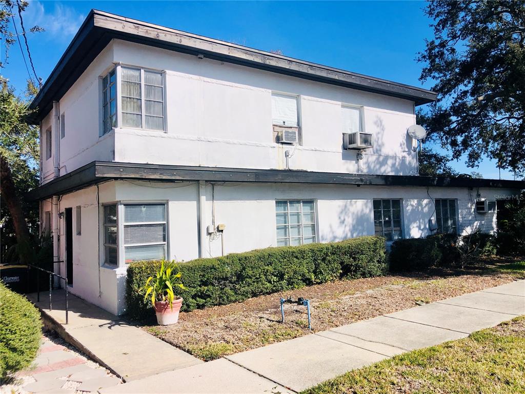 A two-story white stucco building with a flat roof and multiple windows — 1762 N FORT HARRISON AVENUE, CLEARWATER, FL