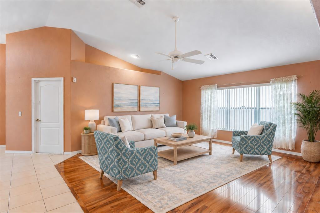 An entryway features peach walls, white trim, a tiled floor, and a white front door — 312 ROYAL PALM WAY, SPRING HILL, FL