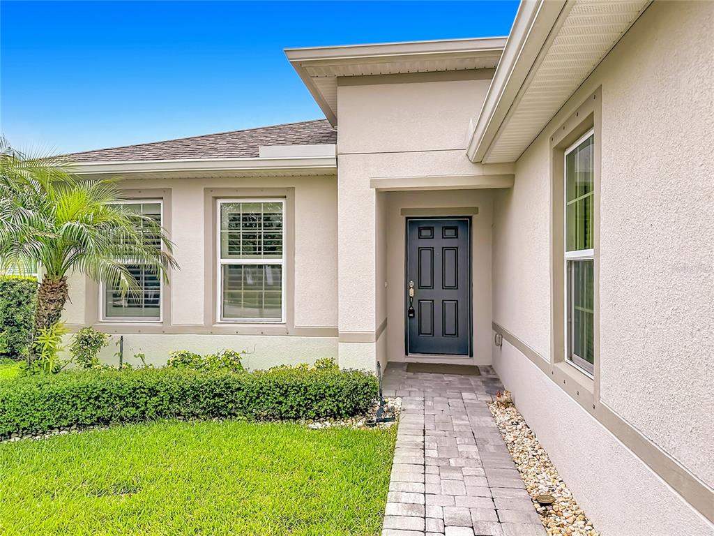 A kitchen features dark cabinetry, granite countertops, stainless steel appliances, and a central island — 3628 SAPPHIRE HOLLOW WAY, FORT PIERCE, FL