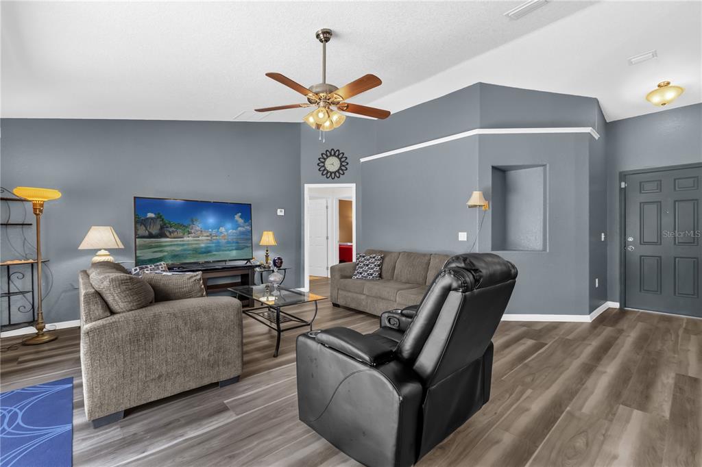 A dining area features a glass-topped table, wooden chairs, and a window with a valance — 8506 SW 136TH LOOP, OCALA, FL