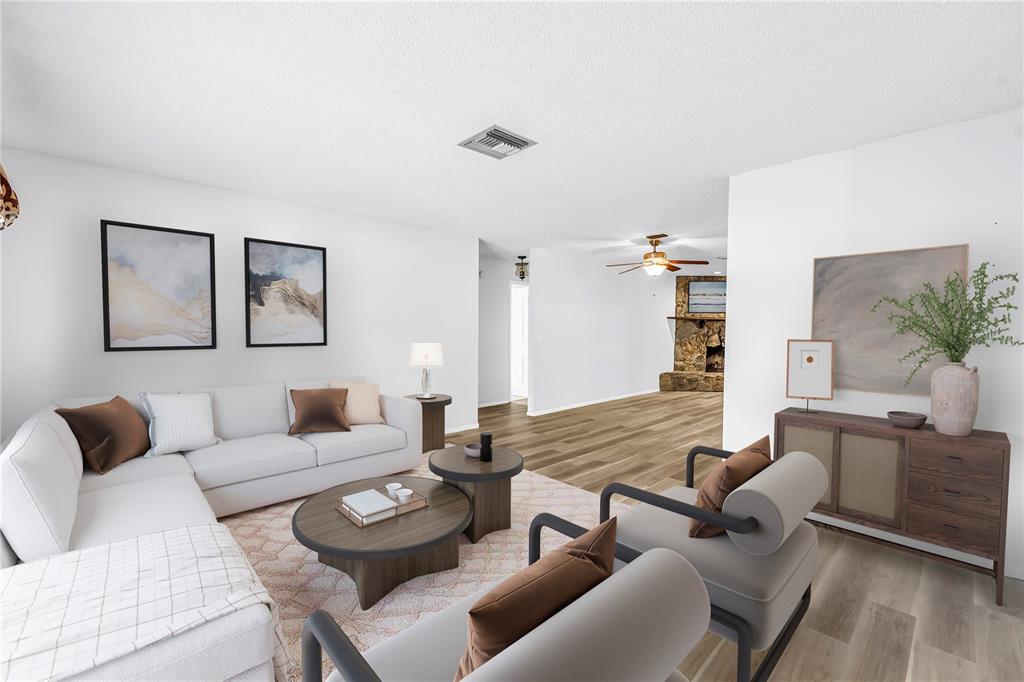 A bright entryway features white walls, wood-look flooring, a white front door, and a ceiling light — 112 MEADOWCROSS DRIVE, SAFETY HARBOR, FL