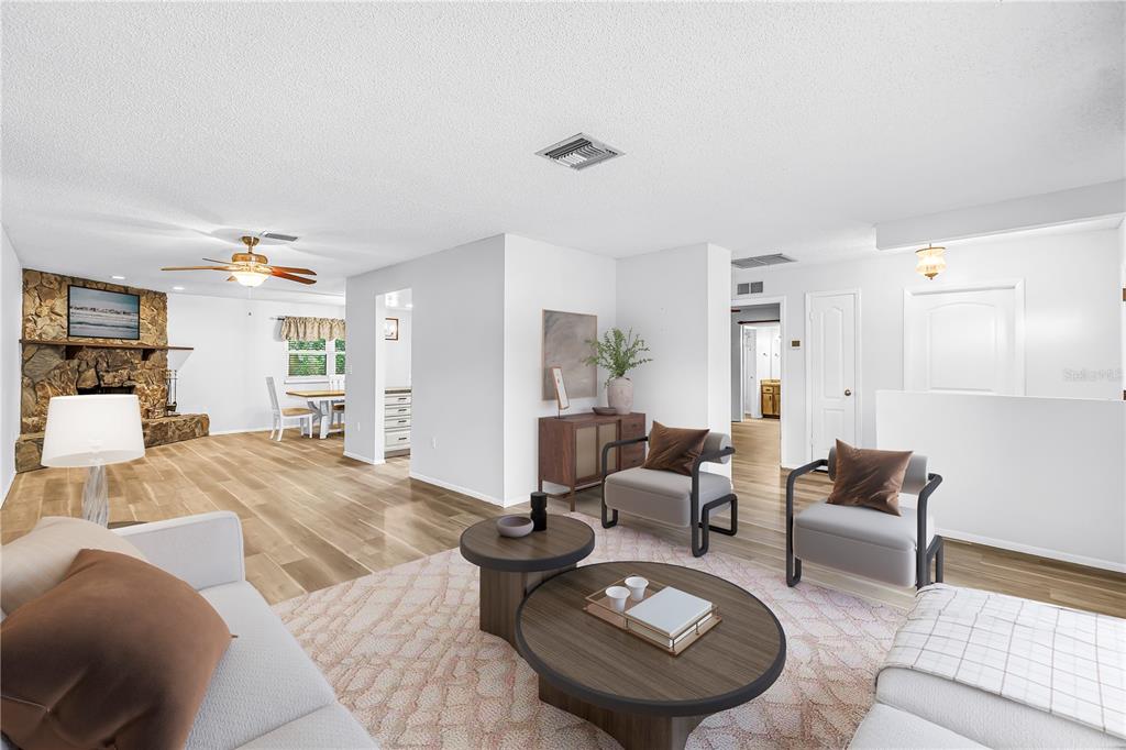 A kitchen features white cabinets, granite countertops, stainless steel appliances, and an adjacent dining area — 112 MEADOWCROSS DRIVE, SAFETY HARBOR, FL
