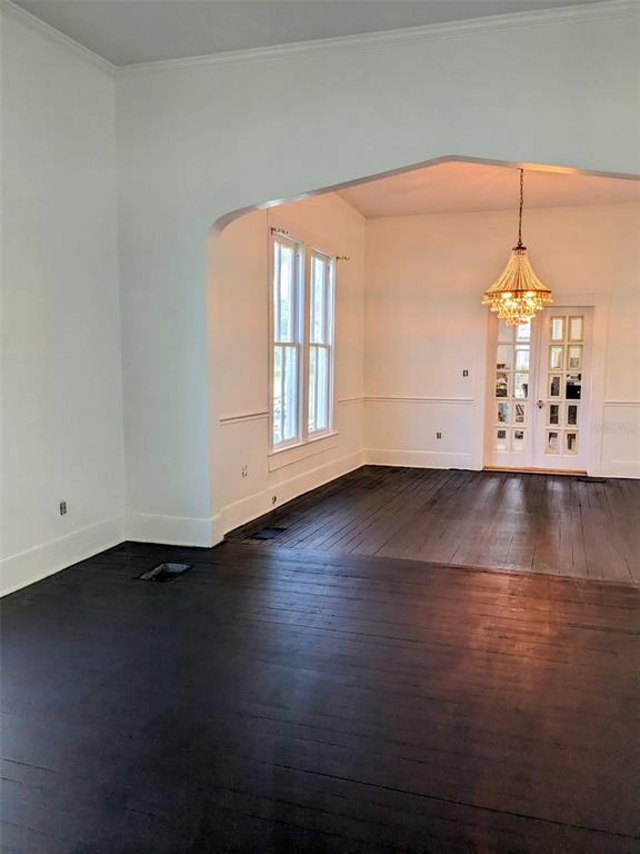 A kitchen features black lower cabinets, white upper cabinets, a gas stove, and wood countertops — 495 E PARKER STREET, BARTOW, FL