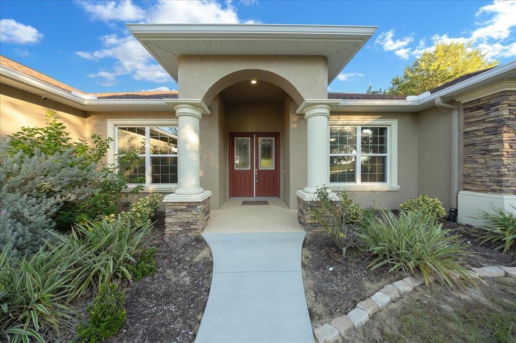 A front entrance with a concrete walkway, two columns, and a double red door — 2087 N ANNAPOLIS AVENUE, HERNANDO, FL