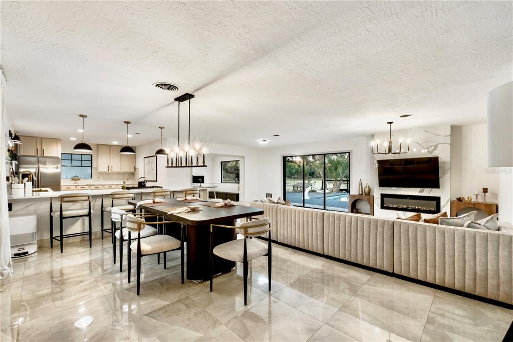 A kitchen features a large white quartz island with a gas cooktop and pendant lighting — 36245 E SPRING LAKE BOULEVARD, FRUITLAND PARK, FL