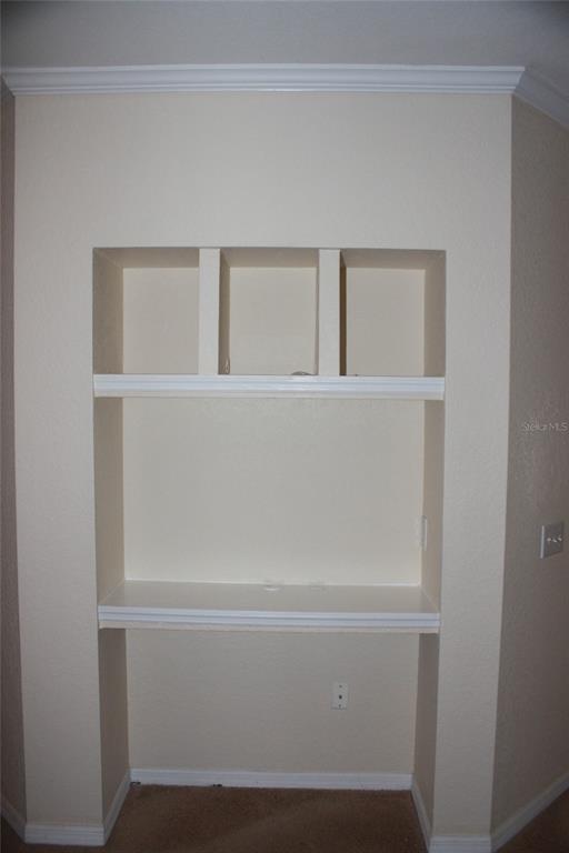 A built-in wall niche with two shelves and a lower desk area in a room — 3561 CONROY ROAD UNIT 234, ORLANDO, FL