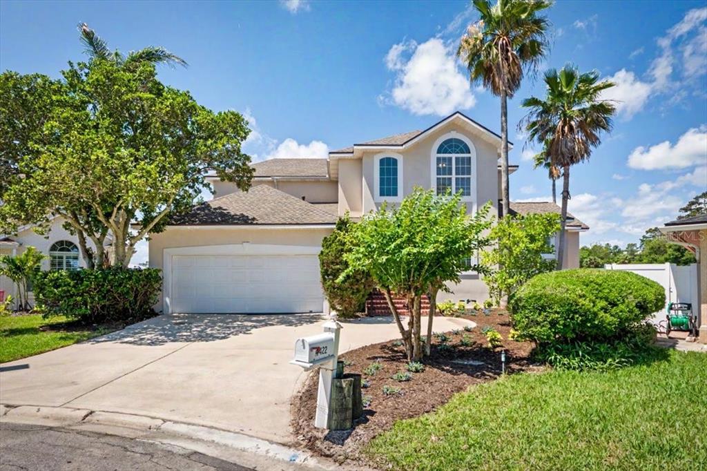 A two-story suburban house with a two-car garage, palm trees, and a concrete driveway — 4422 TIDEVIEW DRIVE, JACKSONVILLE, FL