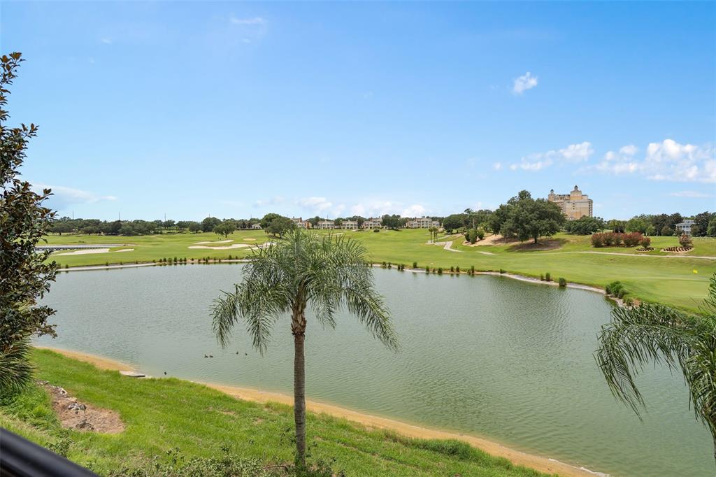 An aerial view shows a residential house highlighted in yellow, situated near a golf course — 1402 TITIAN COURT, REUNION, FL