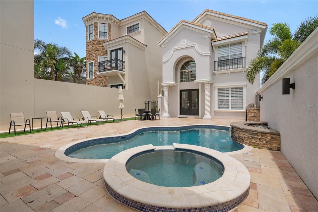 An aerial view shows several suburban houses bordering a golf course on a sunny day — 1402 TITIAN COURT, REUNION, FL