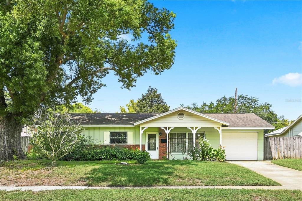A single-story house with light green siding, a brick base, and an attached garage — 622 MARTIN AVENUE, ALTAMONTE SPRINGS, FL