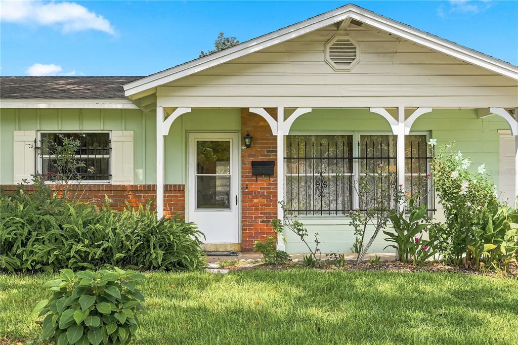 A single-story house with light green siding, a brick facade, and a covered front porch — 622 MARTIN AVENUE, ALTAMONTE SPRINGS, FL