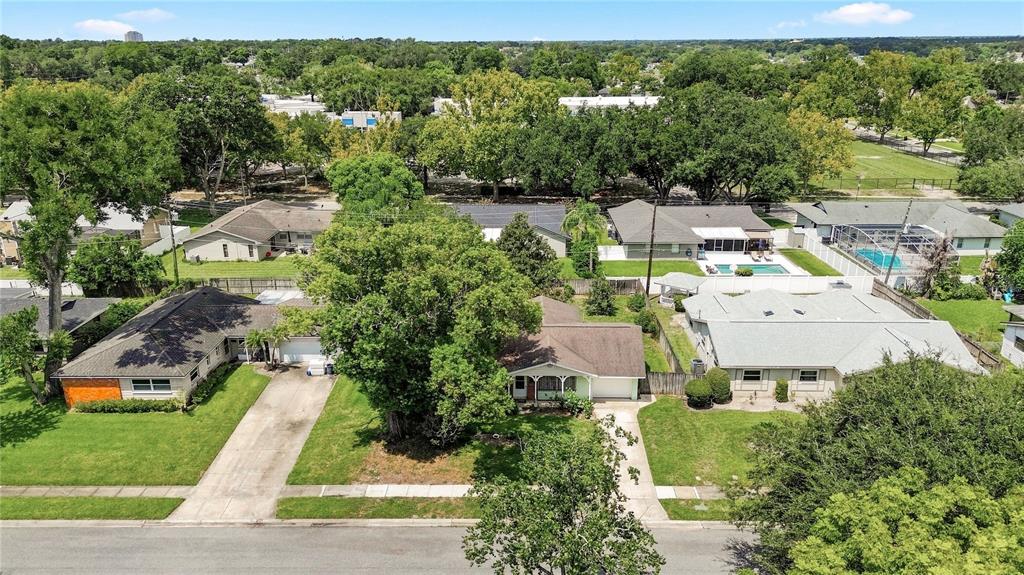 An aerial view shows three suburban houses with driveways, lawns, and mature trees — 622 MARTIN AVENUE, ALTAMONTE SPRINGS, FL