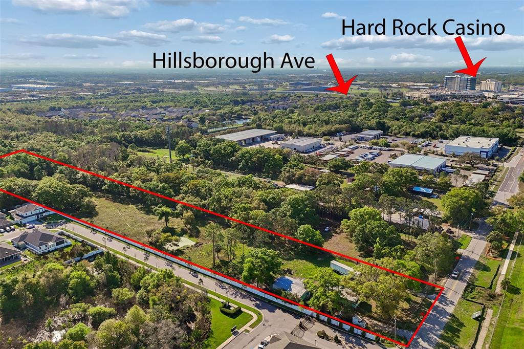 An aerial view shows a rectangular plot of land outlined in red near commercial buildings — 6213 ORIENT ROAD, TAMPA, FL