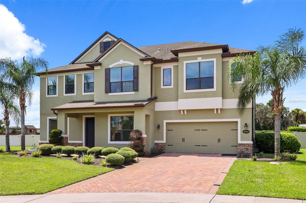 A rectangular swimming pool with a water feature sits in a fenced backyard — 17112 GUILFORD COURT, ORLANDO, FL