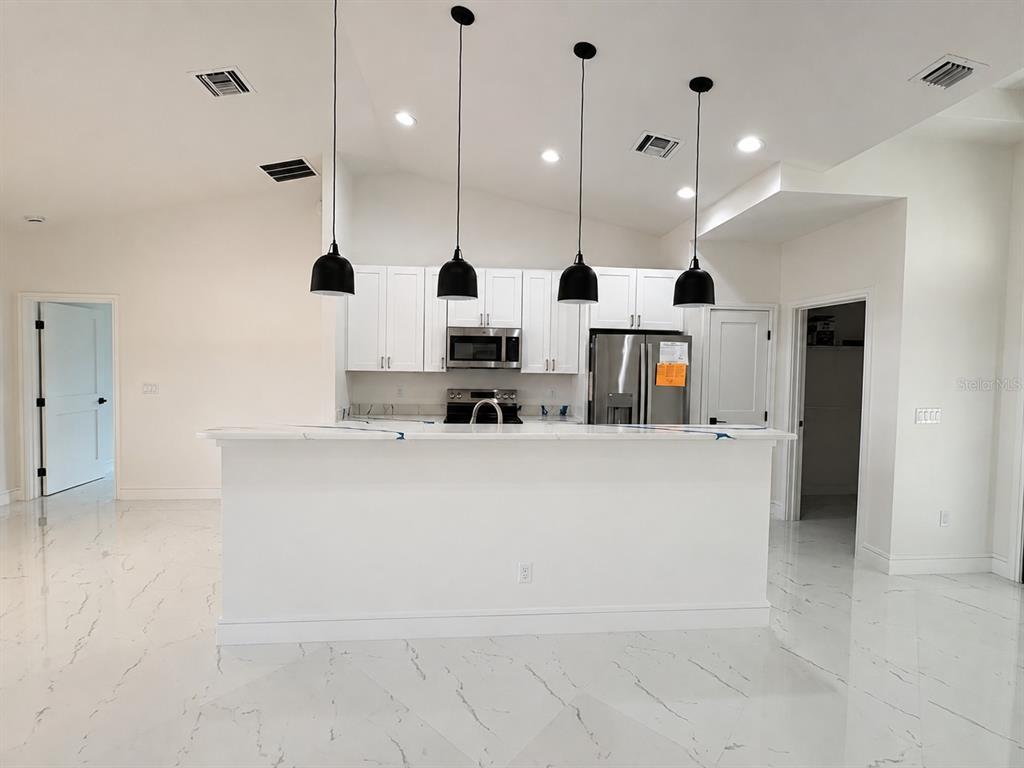 A single-story house with a white exterior, brown trim, and a two-car garage — 2356 30TH AVENUE SW, VERO BEACH, FL